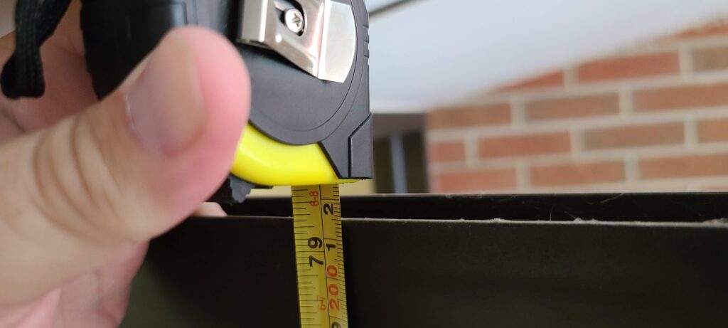 Marietta locksmith taking exact measurement for door replacement